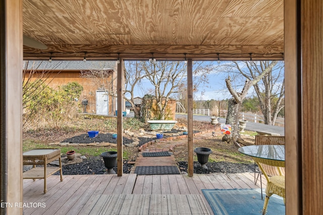 doorway to outside featuring wooden ceiling, floor to ceiling windows, and wood finished floors