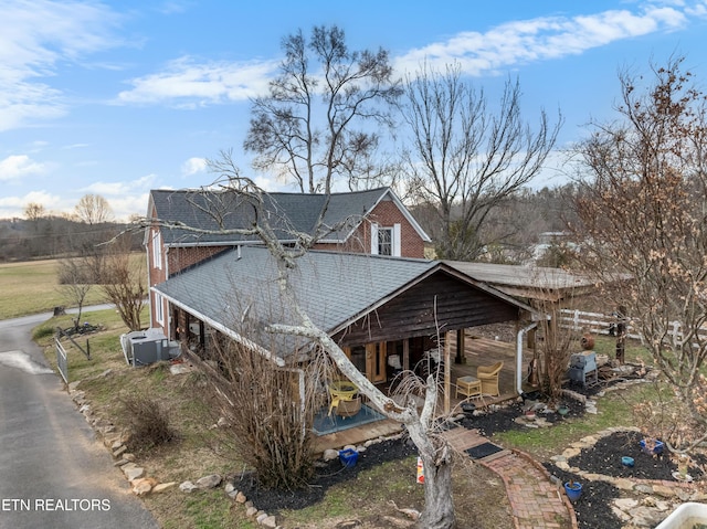 view of front of property featuring roof with shingles