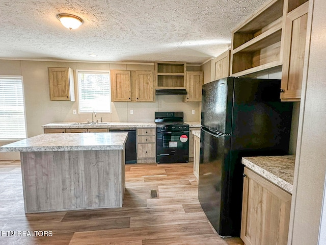 kitchen with light brown cabinetry, sink, black appliances, light hardwood / wood-style flooring, and a kitchen island