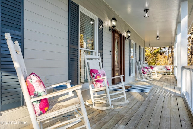 wooden terrace featuring covered porch