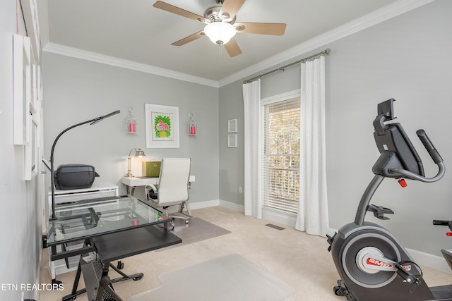 office space featuring light carpet, ceiling fan, and crown molding