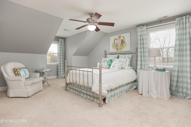 bedroom with ceiling fan, carpet floors, and lofted ceiling