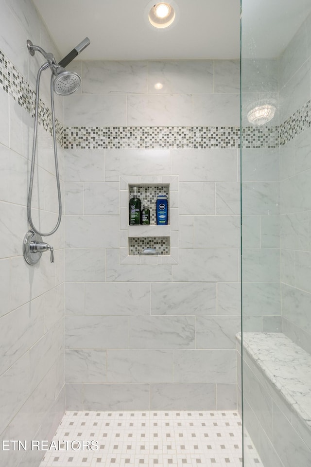 bathroom with a tile shower