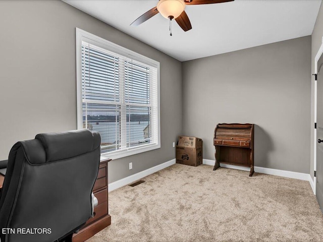 carpeted office space featuring a wealth of natural light and ceiling fan