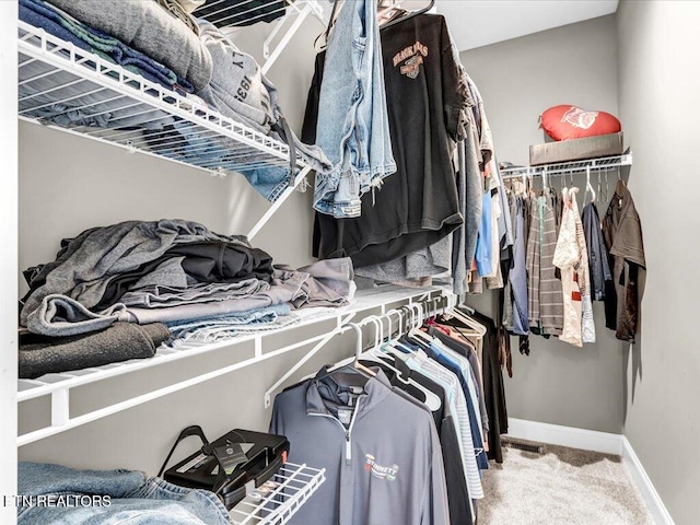 walk in closet with carpet flooring