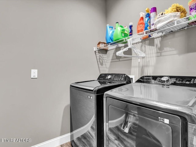 laundry area with wood-type flooring and independent washer and dryer