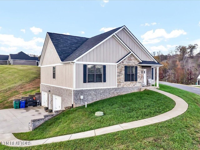 view of front of home with a front yard and a garage