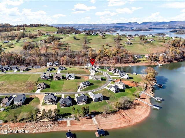 drone / aerial view featuring a water and mountain view