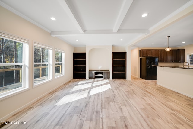 unfurnished living room with crown molding, beam ceiling, and light hardwood / wood-style floors