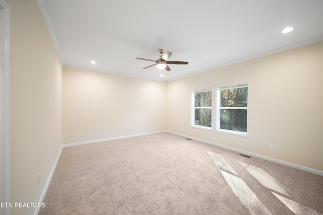 carpeted empty room with ornamental molding and ceiling fan