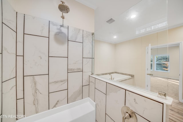 bathroom with crown molding and shower with separate bathtub