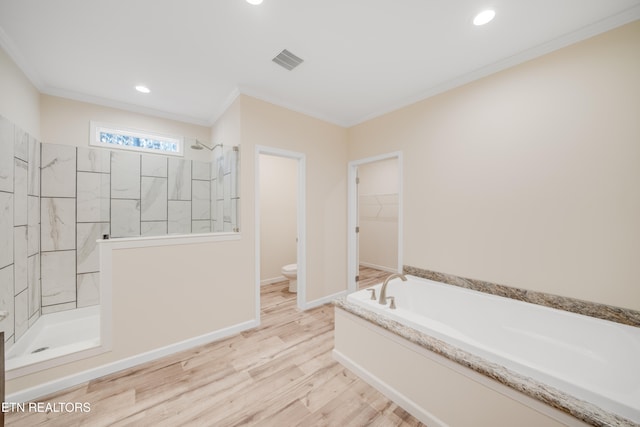 bathroom featuring crown molding, toilet, independent shower and bath, and hardwood / wood-style floors