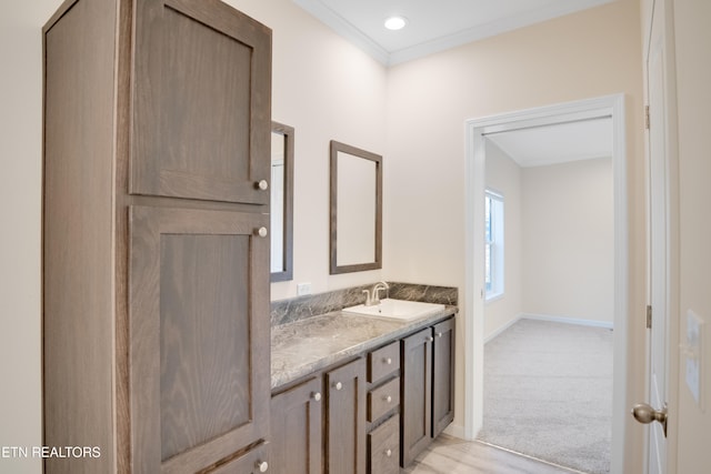 bathroom featuring ornamental molding and vanity