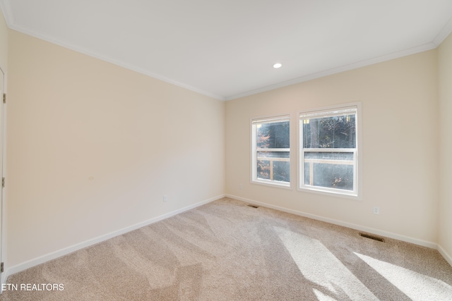 carpeted spare room with crown molding