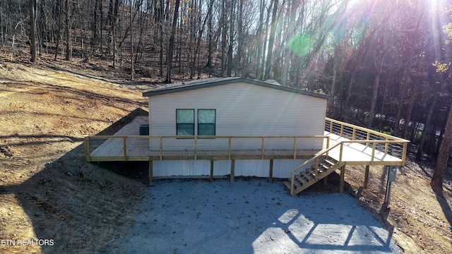 view of property exterior with a wooden deck