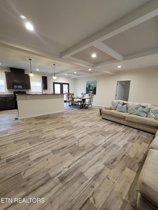 living room featuring beam ceiling and light hardwood / wood-style floors