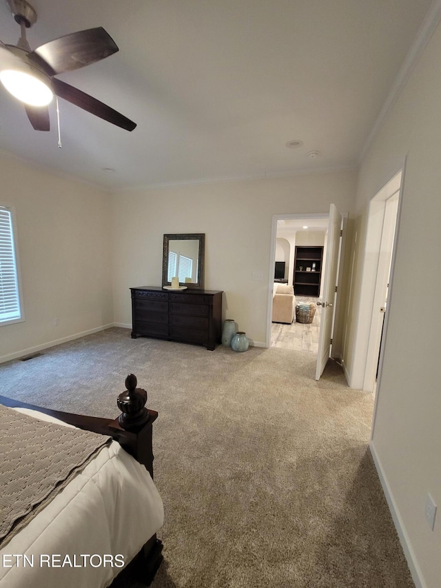 unfurnished bedroom featuring crown molding, ceiling fan, and light colored carpet