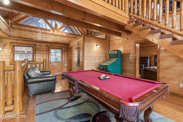 game room with hardwood / wood-style flooring, vaulted ceiling with beams, wooden walls, and billiards