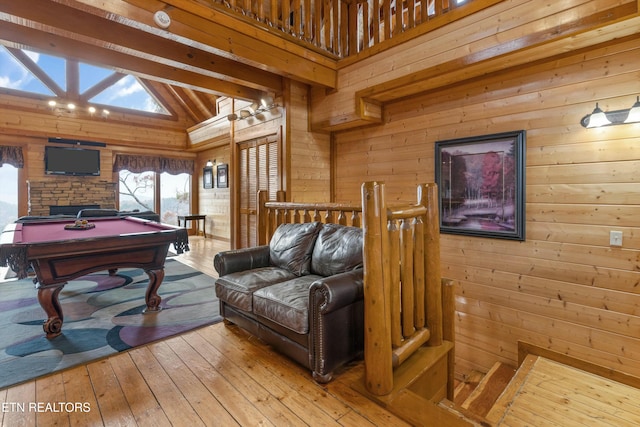 game room with wood walls, lofted ceiling with beams, light hardwood / wood-style floors, and pool table