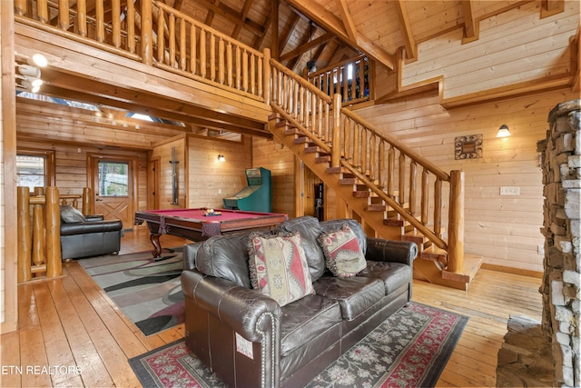 living room featuring wood ceiling, wood walls, beamed ceiling, hardwood / wood-style floors, and pool table