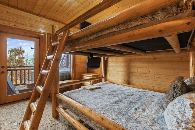 bedroom featuring carpet flooring, access to outside, wooden walls, and wood ceiling