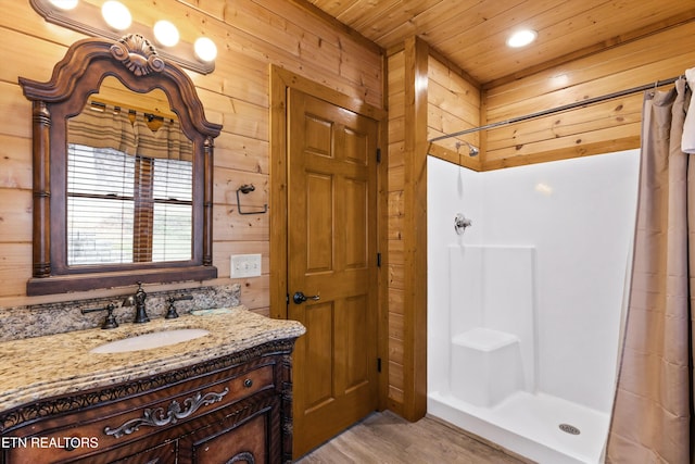 bathroom with wood-type flooring, walk in shower, wooden walls, and wooden ceiling