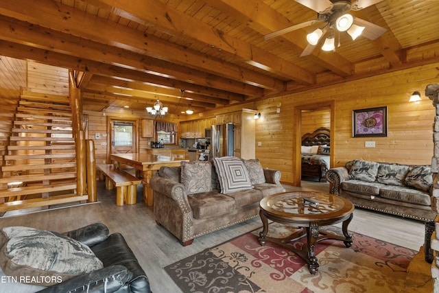 living room featuring beamed ceiling, light hardwood / wood-style floors, wooden ceiling, and wooden walls