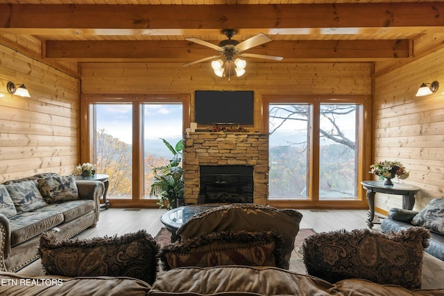 living room with hardwood / wood-style floors, wood ceiling, ceiling fan, and beam ceiling