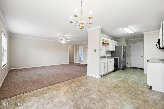 kitchen featuring white cabinets, light colored carpet, ornamental molding, and sink