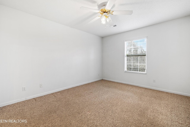 carpeted empty room featuring ceiling fan