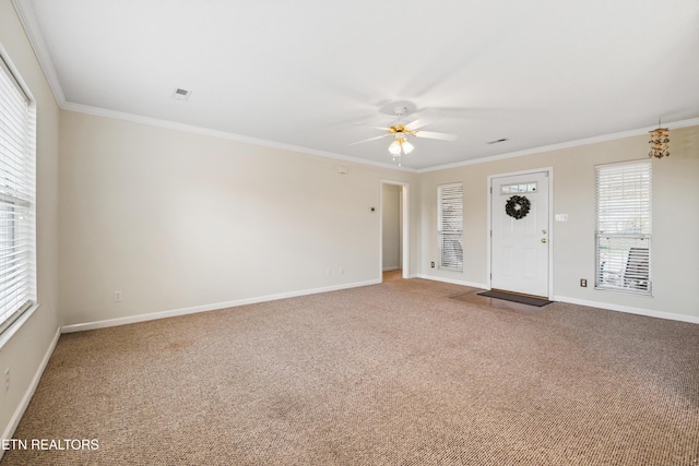 interior space featuring carpet flooring, ceiling fan, and ornamental molding