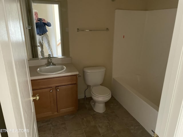 bathroom with tile patterned floors, vanity, and toilet