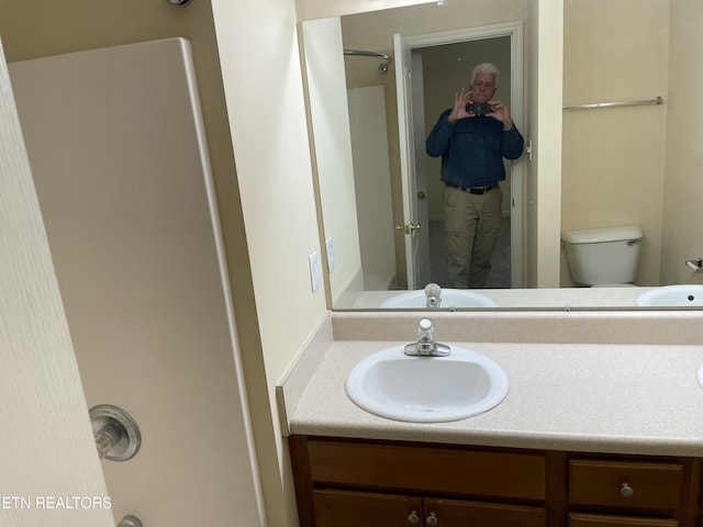 bathroom with vanity and toilet