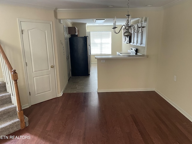 interior space featuring crown molding and dark wood-type flooring