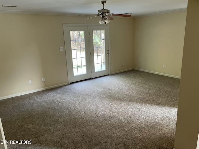 empty room with carpet flooring, crown molding, and ceiling fan