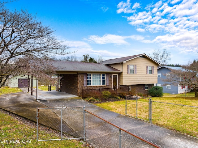 tri-level home with a front lawn, fence, an outdoor structure, an attached carport, and brick siding