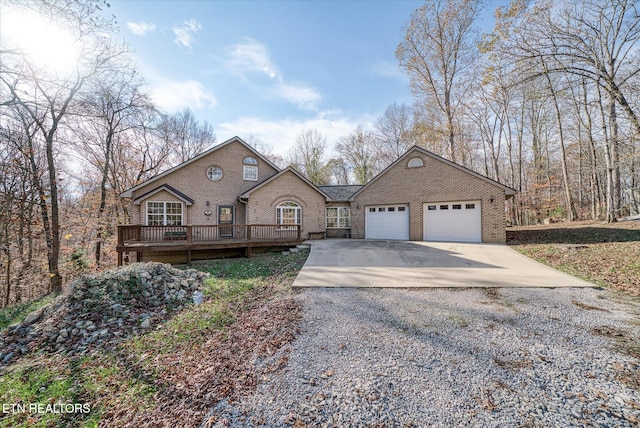 view of front facade with a garage and a wooden deck