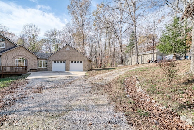 view of property exterior with a deck and a garage