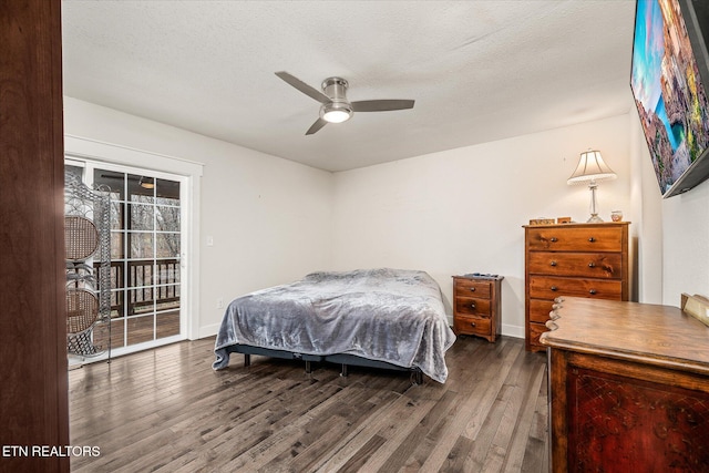 bedroom featuring access to outside, ceiling fan, dark wood-type flooring, and a textured ceiling