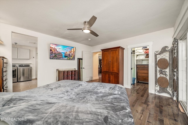 bedroom featuring a walk in closet, ceiling fan, independent washer and dryer, dark hardwood / wood-style floors, and a closet