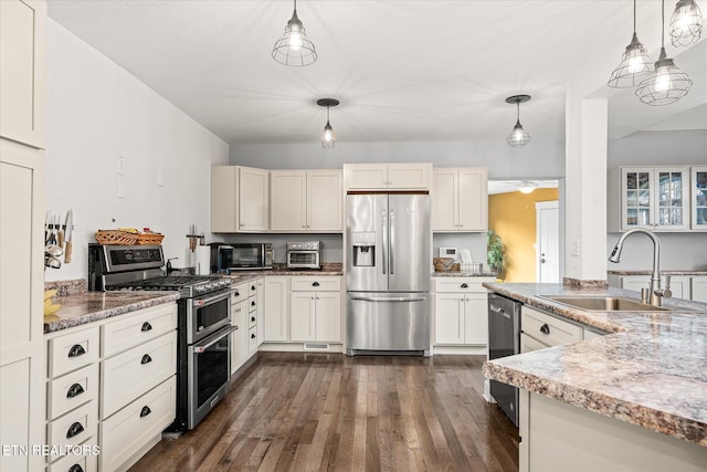 kitchen featuring sink, stainless steel appliances, and hanging light fixtures