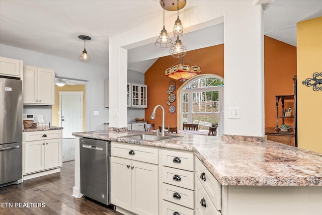 kitchen with pendant lighting, dark wood-type flooring, sink, ceiling fan, and appliances with stainless steel finishes