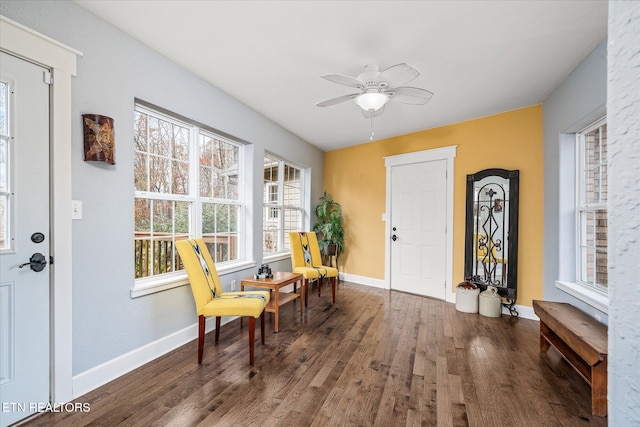 sitting room featuring ceiling fan and dark hardwood / wood-style floors