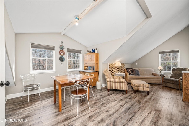 interior space featuring vaulted ceiling with beams and hardwood / wood-style flooring