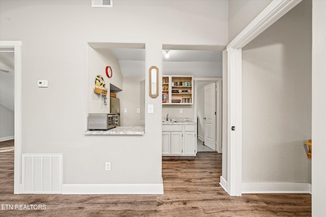 interior space with hardwood / wood-style floors and sink