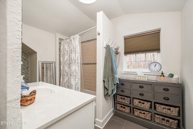 bathroom featuring tile patterned flooring, vanity, walk in shower, and vaulted ceiling