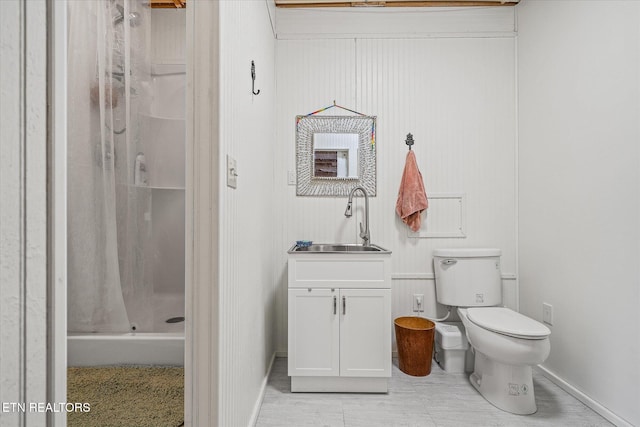 bathroom featuring a shower, vanity, and toilet