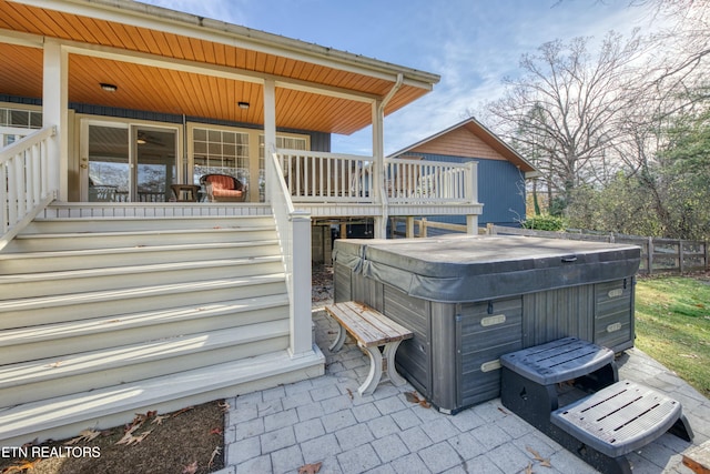 wooden terrace featuring a hot tub