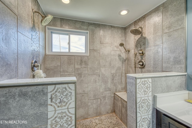 bathroom featuring vanity and tiled shower