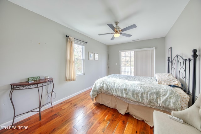 bedroom with ceiling fan and wood-type flooring